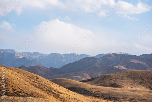 Foggy landscape unusual mountains with cloudy skies. Autumn in remote foothills in northern China. Dry grass and hills. Natural background. Exploration of new places, travel to remote locations.