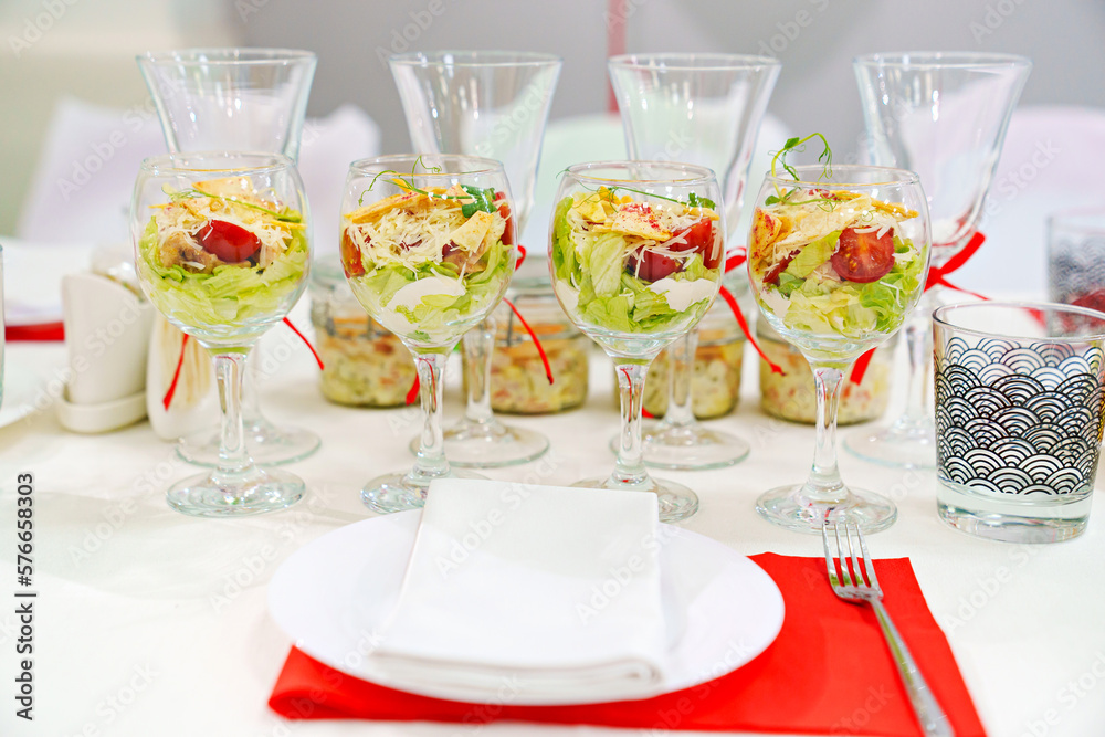 Fototapeta premium original serving of portioned salads on the table. catering.