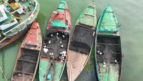 Kishoreganj, Bangladesh - 06 November 2022: Aerial view of people working along the riverbank unloading coal from boats, Bhairab Upazila. photo