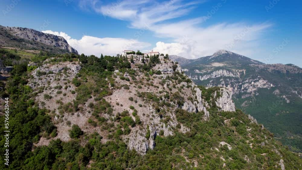flight towards a medieval hamlet (chateau de Gourdon) perched on the edge of a cliff, with ancient sand colored houses and a steeple. flight towards a medieval hamlet (chateau de Gourdon) perched on the edge of a cliff, with ancient sand colored houses and a steeple.