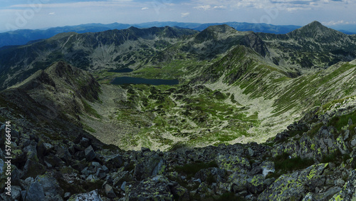Panorama above the high summits of Retezat Mountains and the glacier Bucura lake beneath them. High altitude landscape with rocky mountains and alpine pastures. Carpathia, Romania. © Alexandru V