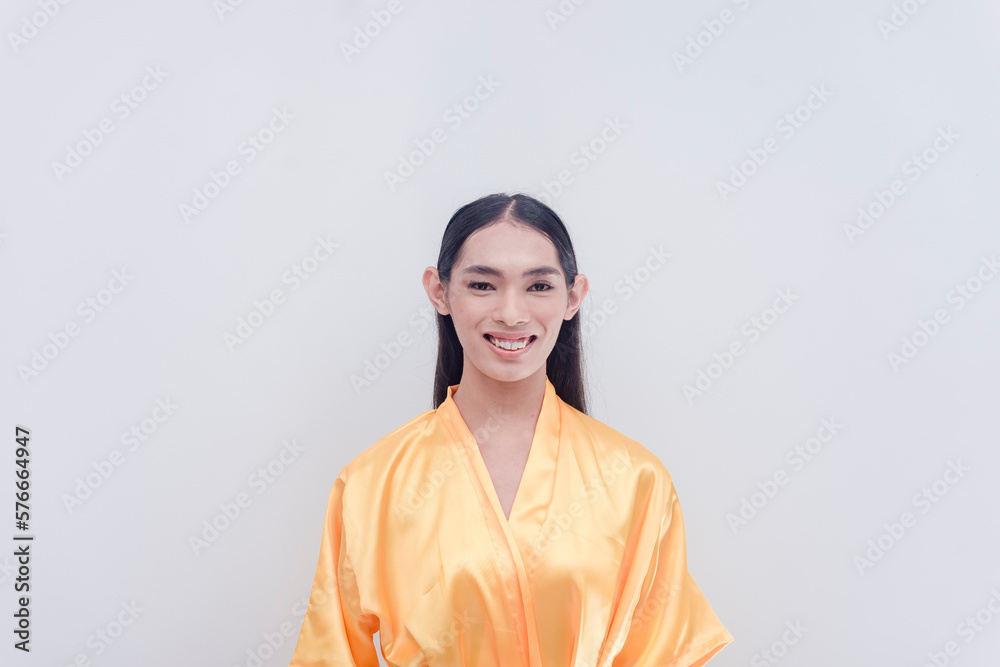 A beautiful Filipina trans-woman dressed in a golden yellow silk satin bathrobe. Studio shot isolated in a white background. A beautiful Filipina trans-woman dressed in a golden yellow silk satin bathrobe. Studio shot isolated in a white background.
