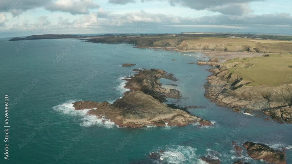 Aerial view of Porthcothan beach along the wild coastline with coves and cliffs, Cornwall, United Kingdom. Aerial view of Porthcothan beach along the wild coastline with coves and cliffs, Cornwall, United Kingdom.