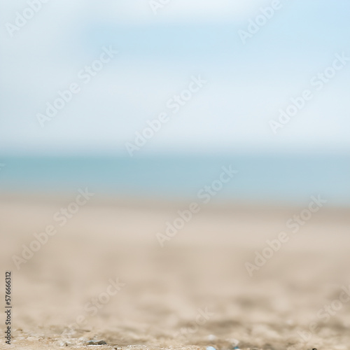 Seascape abstract beach background. blur bokeh light of calm sea and sky. Focus on sand foreground ai generative © dea