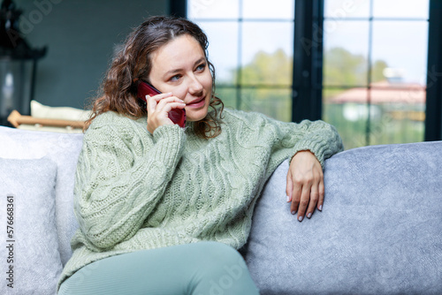 Young woman talking on the phone at home.Young woman talking on the phone at home