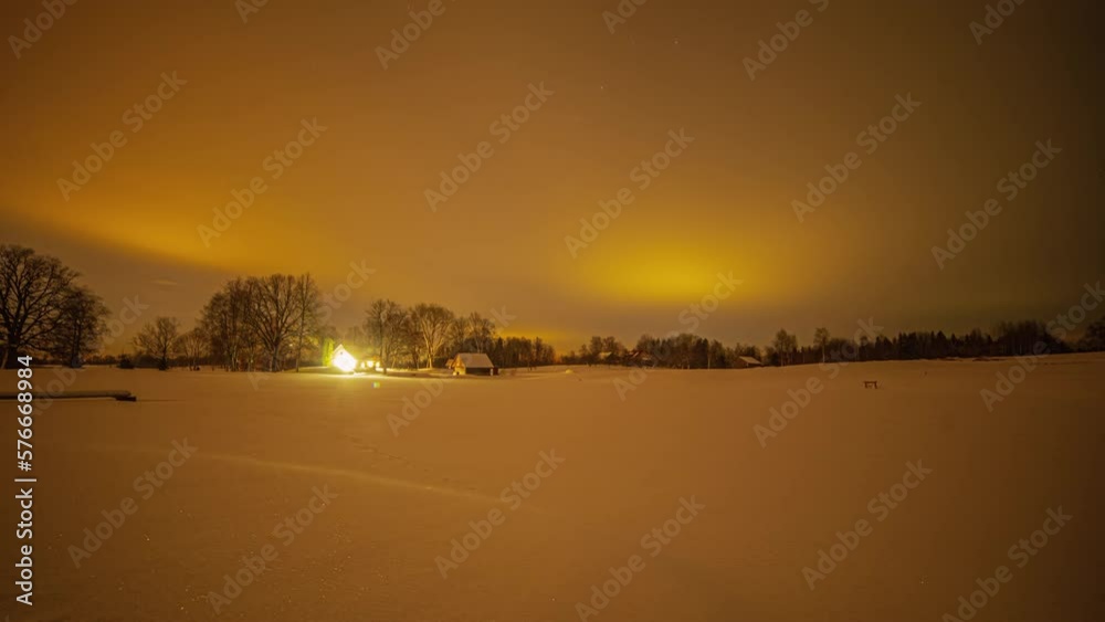 Night-to-day timelapse of a house under an open sky and some trees are in the background Night-to-day timelapse of a house under an open sky and some trees are in the background