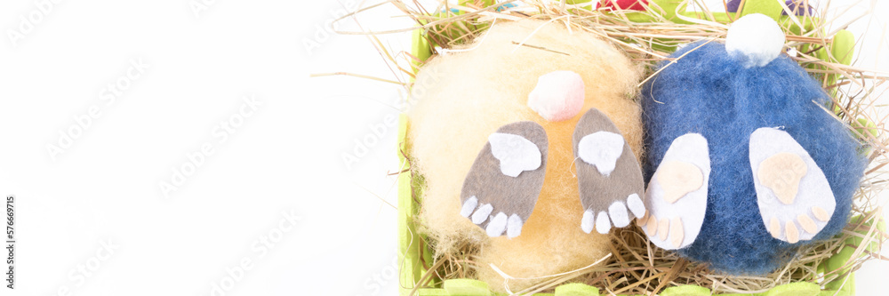 two handmade fluffy easter bunnys and colorful eggs