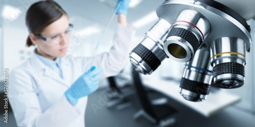 Scientist person working with microscope in laboratory.