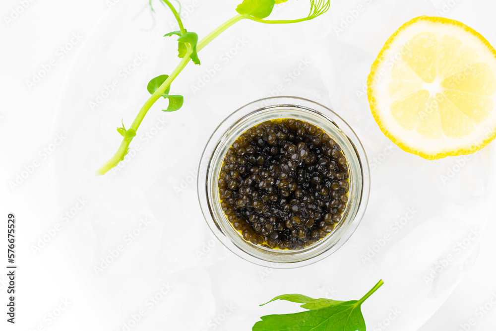Appetizers of natural sturgeon black caviar, lemon and parsley