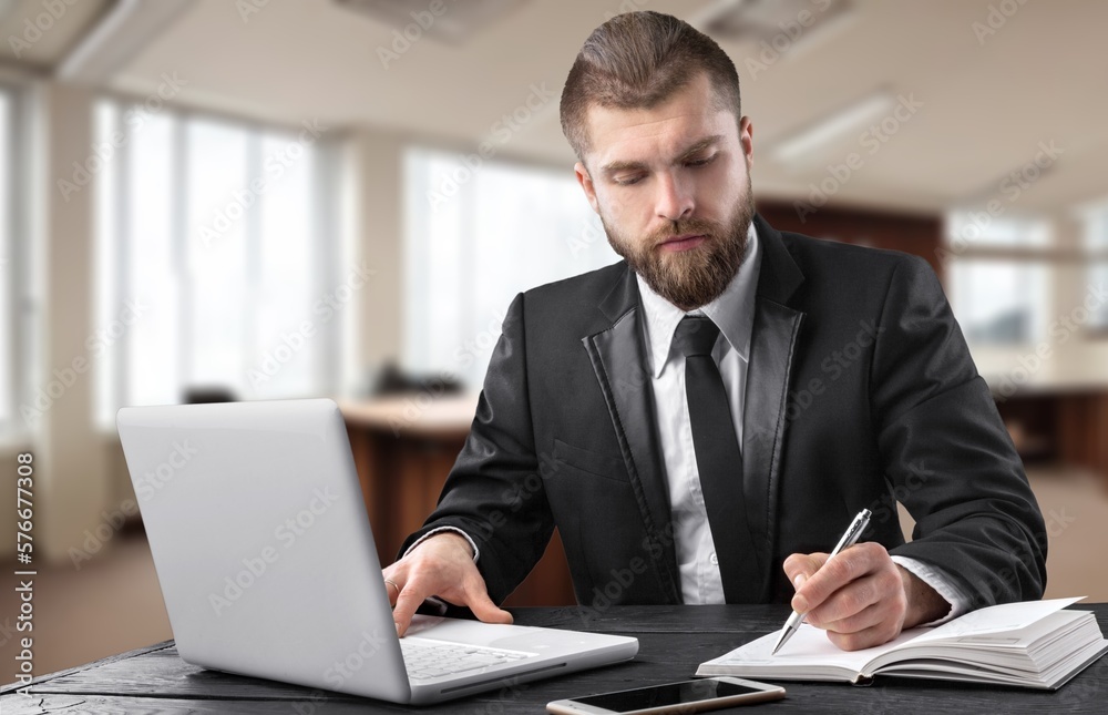 Busy businessman working in office on computer Busy businessman working in office on computer
