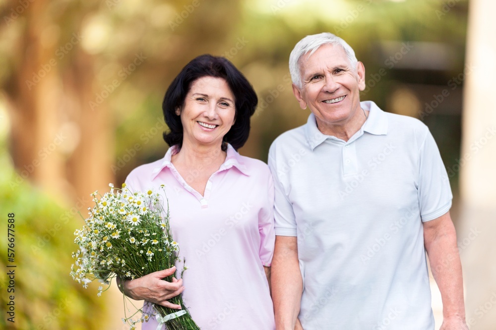 Happy senior old couple walking on outdoor background Happy senior old couple walking on outdoor background