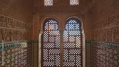Camera moves to arches of the window between the walls with Moorish ornaments. Magnificent moorish interior in Alhambra palace, Granada. Gimbal shot, 4K