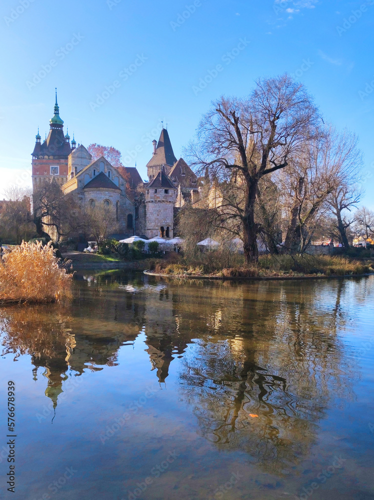 Museum of Agriculture in Budapest reflected in the lake in the park in bright winter day