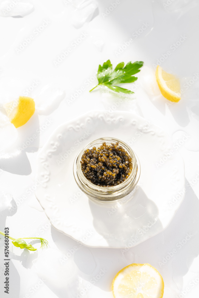 Appetizers of natural sturgeon black caviar, lemon and parsley