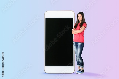 Young beautiful woman with huge mobile phone