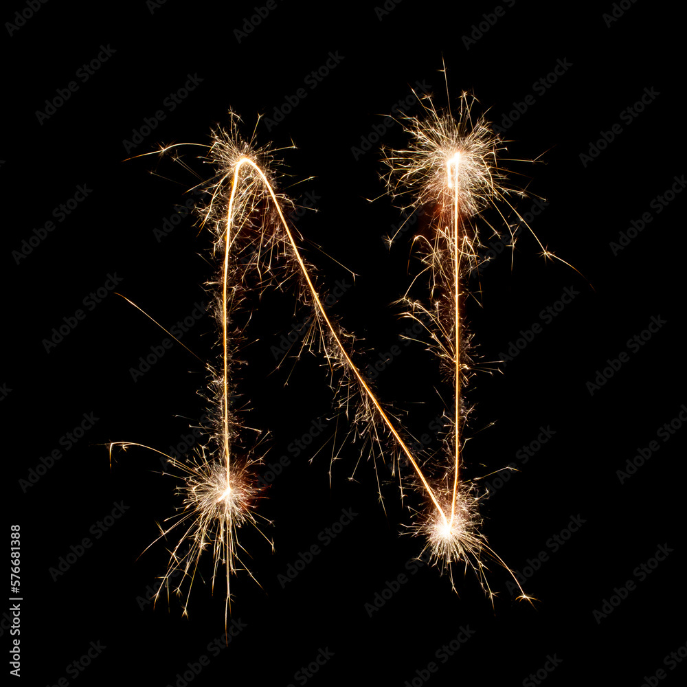 Sparkling burning creative letter N isolated on black background. Beautiful glowing golden overlay object for design holiday greeting card. Creative lettering N written with burning sparklers Sparkling burning creative letter N isolated on black background. Beautiful glowing golden overlay object for design holiday greeting card. Creative lettering N written with burning sparklers