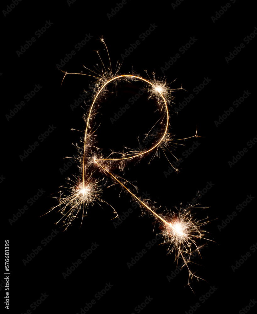 Sparkling burning creative letter R isolated on black background. Beautiful glowing golden overlay object for design holiday greeting card. Creative lettering R written with burning sparklers