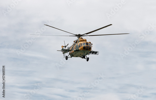 Military helicopter in the cloudy sky.