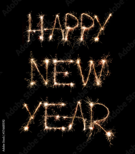 Sparkling burning creative text Happy New Year isolated on black background. Beautiful glowing golden overlay object for design holiday greeting card. Creative lettering written with burning sparklers