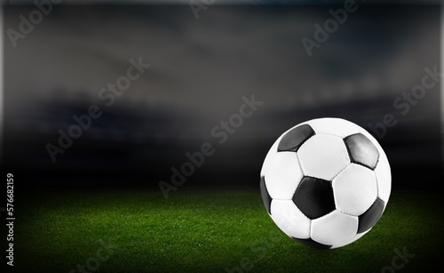 Official football ball on green stadium grass © BillionPhotos.com