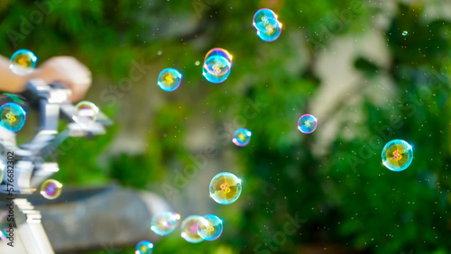 children playing with soap bubbles on summer vacation,toninf background 