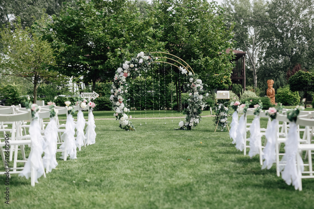 Wedding. Wedding ceremony. Arch decorated with flowers in the area of the wedding ceremony. Wedding decorations