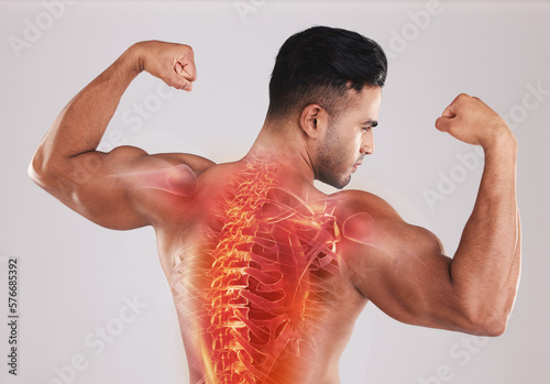 Back, man and spine with x ray, fitness and bicep arms with guy against grey studio background. Male athlete, bodybuilder and gentleman after training, health and strong with anatomy and skeleton