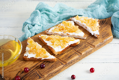 Photos Toasts with caramelized onions and honey. Roasted bread snack