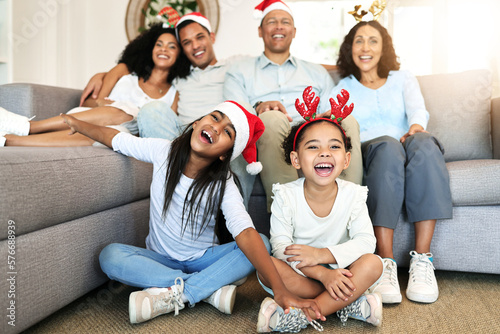 Christmas, smile and portrait of big family on sofa in home living room, bonding and laughing at funny joke. Love, xmas holiday and care of happy children, parents and grandparents sitting on couch. © Allistair F/peopleimages.com
