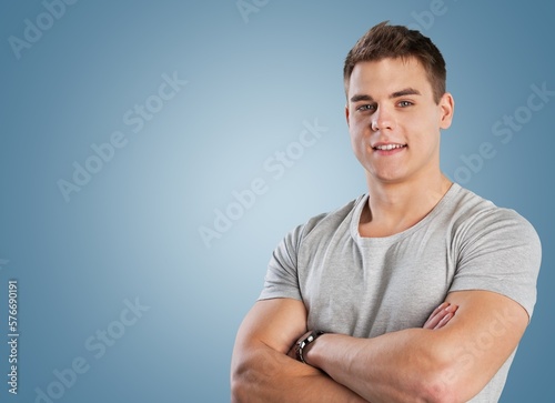 Smiling young man posing on background
