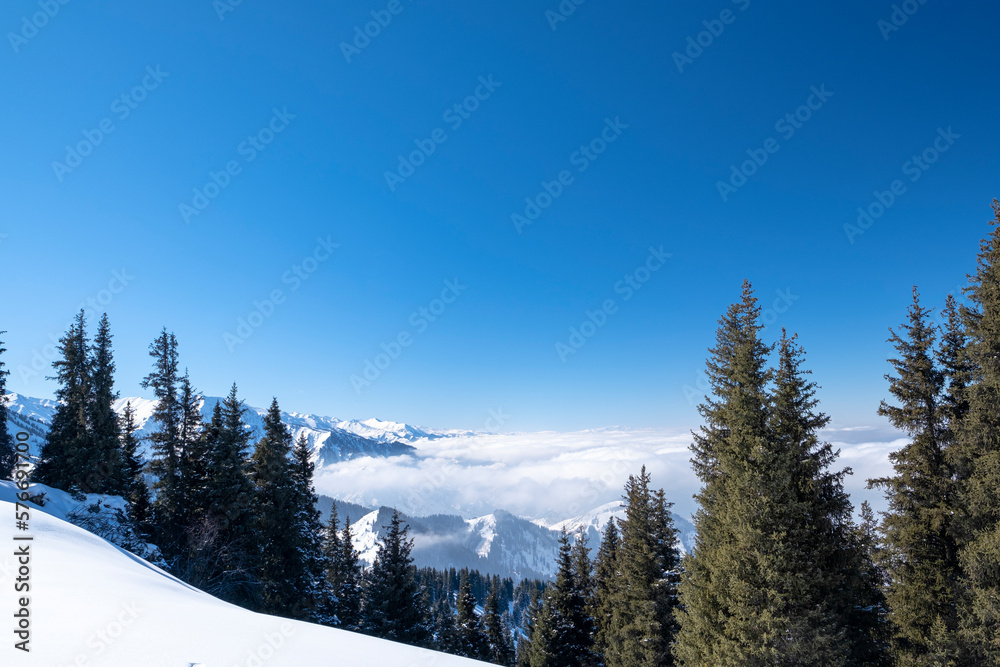 Winter landscape in the mountains above the clouds. Beautiful view of the sea from the clouds high in the mountains.