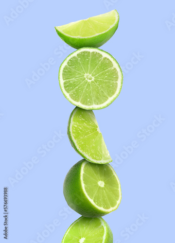 Stacked cut limes on light pale blue background