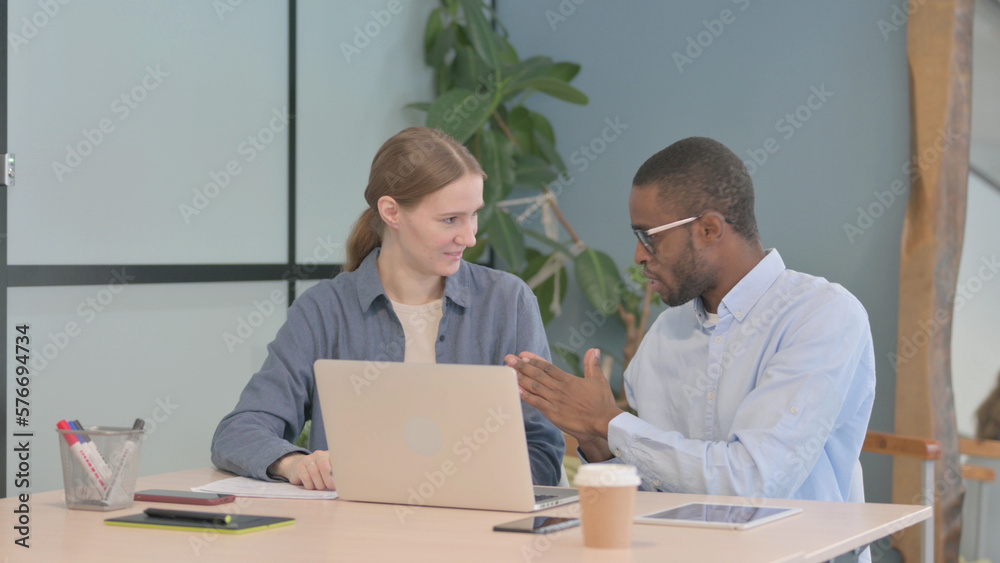 Mixed Race Young Business People Discussing Work, Paperwork Mixed Race Young Business People Discussing Work, Paperwork