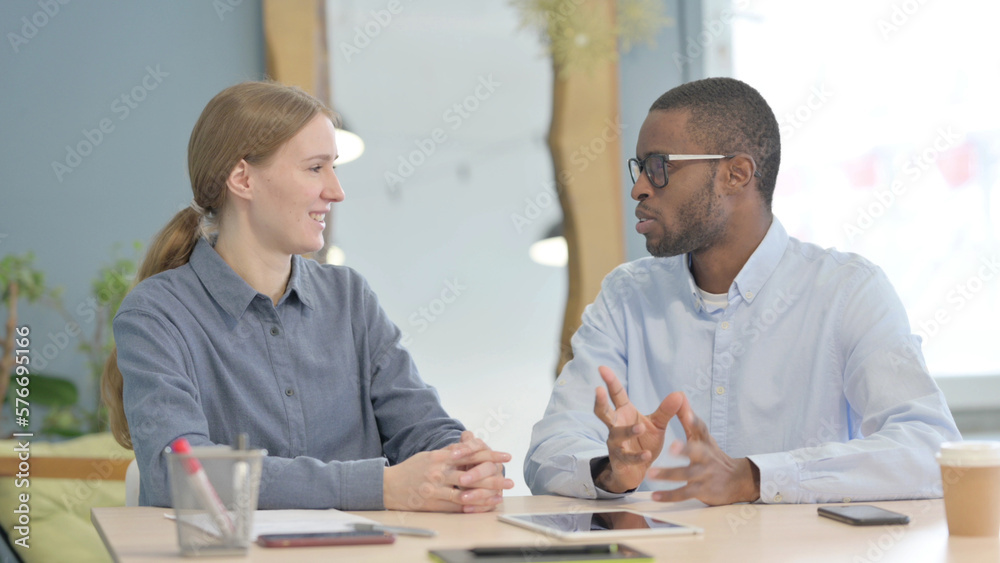 Young Business People Discussing Work in Office Young Business People Discussing Work in Office