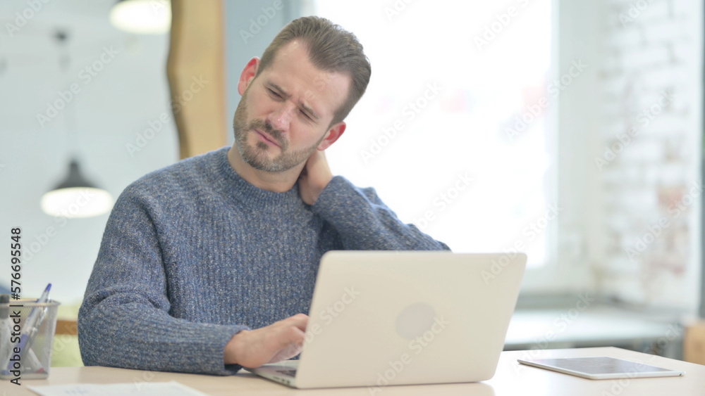 Middle Aged Man having Neck Pain while using Laptop