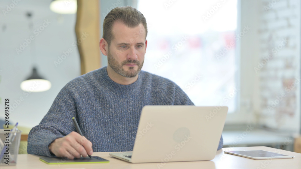 Middle Aged Graphic Designer Working with Graphic Tablet Middle Aged Graphic Designer Working with Graphic Tablet