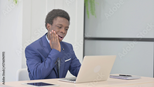 African Businessman having Toothache at Work
