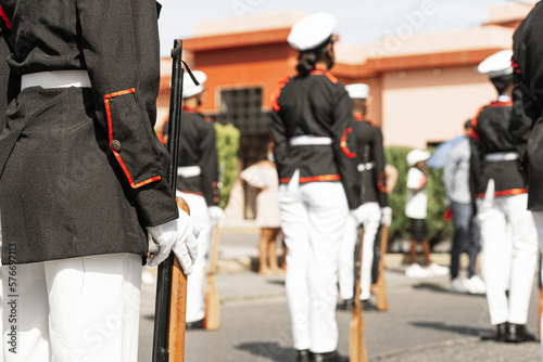 Military's in formation to patriot parade of Honduras, holding rifles on the street.