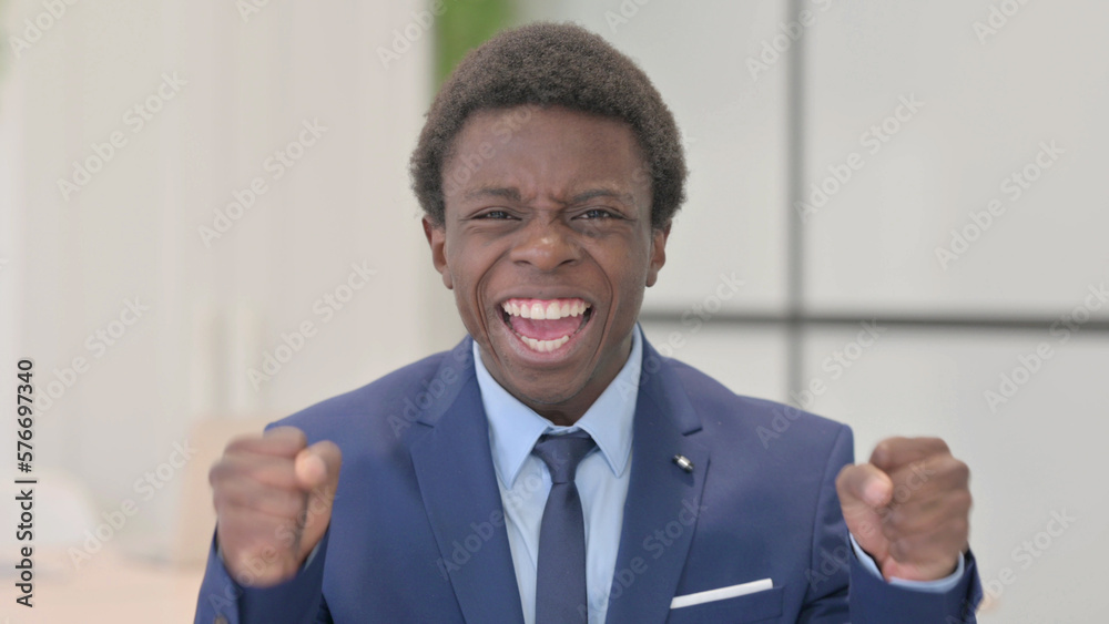 Excited Young African Businessman Celebrating Success, Feeling Happy Excited Young African Businessman Celebrating Success, Feeling Happy