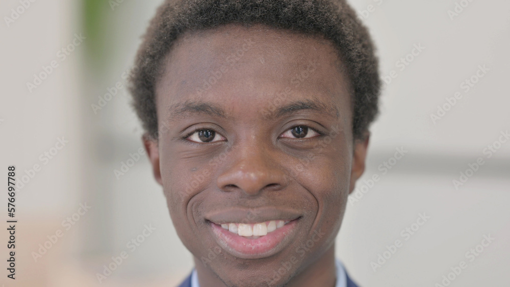 Close Up of Smiling Young African Businessman Face