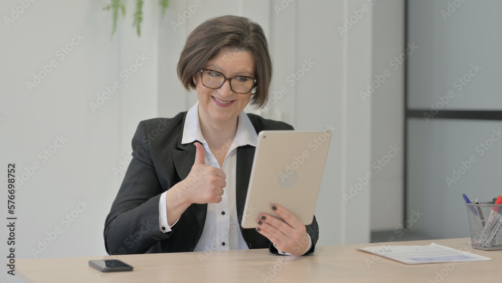 Old Businesswoman Celebrating Win on Digital Tablet Old Businesswoman Celebrating Win on Digital Tablet
