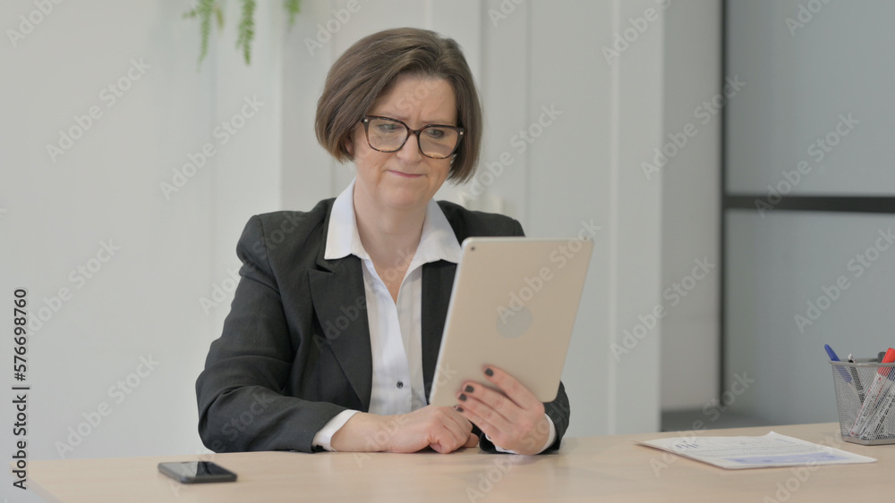 Old Businesswoman Reacting to Loss on Digital Tablet Old Businesswoman Reacting to Loss on Digital Tablet