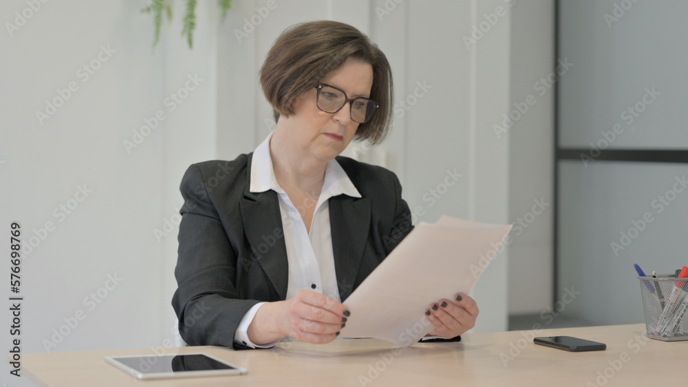 Old Businesswoman Reading Documents in Office, Paperwork Old Businesswoman Reading Documents in Office, Paperwork