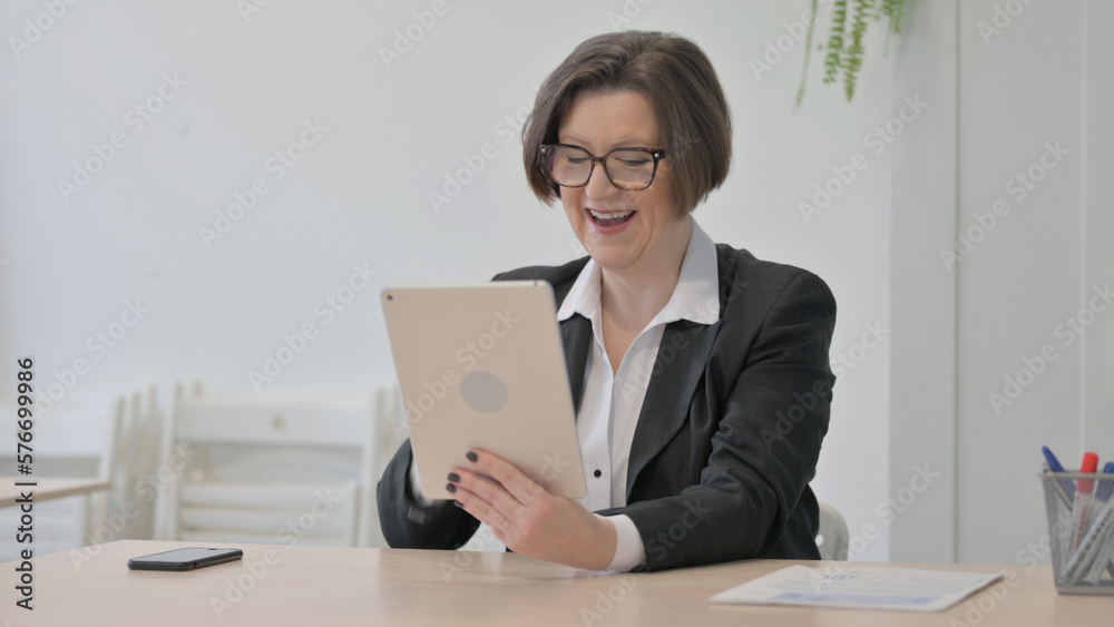 Old Businesswoman Celebrating Win on Digital Tablet Old Businesswoman Celebrating Win on Digital Tablet