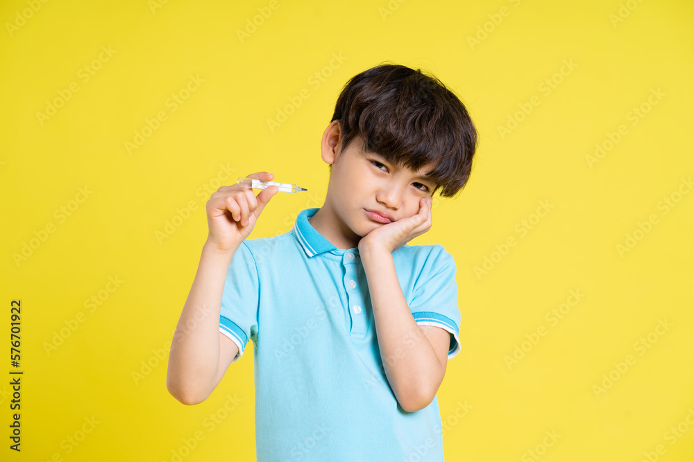 portrait of an asian boy posing on a yellow background portrait of an asian boy posing on a yellow background
