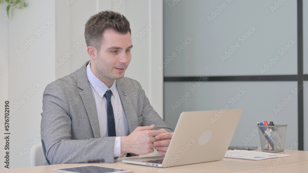 Young Businessman Doing Video Chat on Laptop Young Businessman Doing Video Chat on Laptop