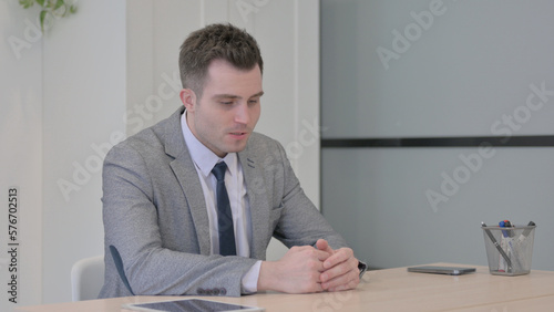 Tense Young Businessman in Frustration and Anxiety in Office