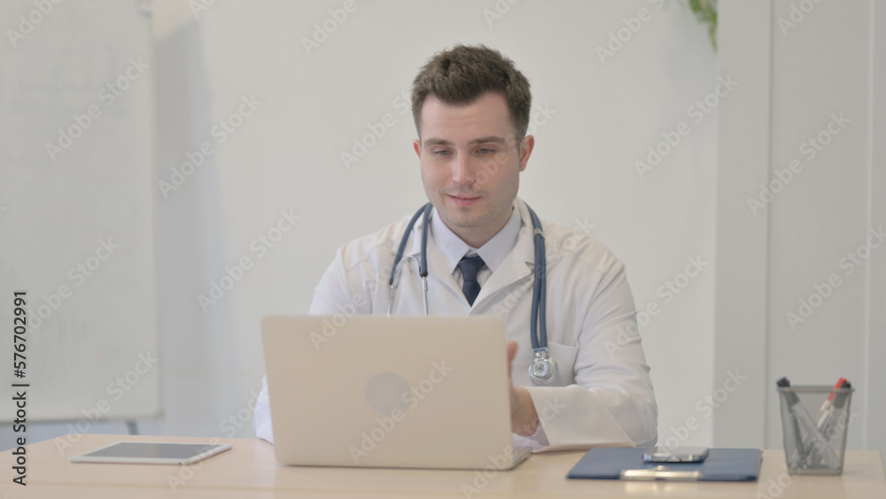 Young Doctor Doing Online Video Chat in Clinic