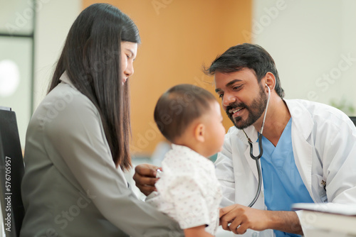 A kind doctor who treats pediatric patients. The child and his family brought him to see the doctor at the hospital because he was ill.