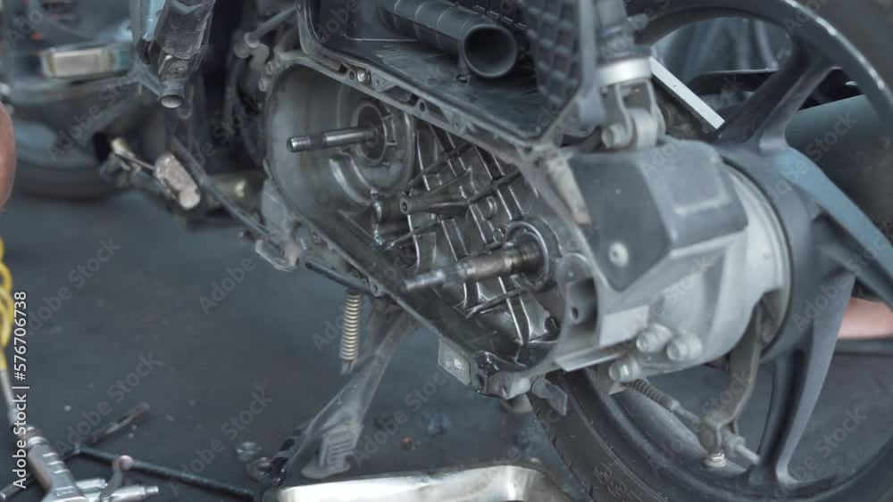 Hands of a mechanic cleaning automatic motorcycle spare parts Hands of a mechanic cleaning automatic motorcycle spare parts